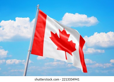 Canada Flag And Blue Sky With Clouds.