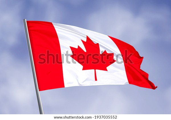 Canada flag isolated on sky\
background. close up waving flag of Canada. flag symbols of\
Canada.