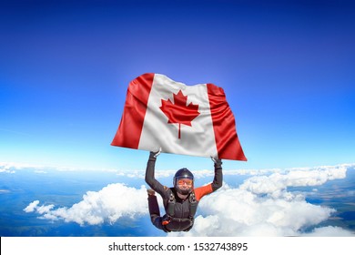 Canada. Flag In Skydiving. People In Free Fall Grab Flag Of Canada. Patriotism, Men And Flag.
