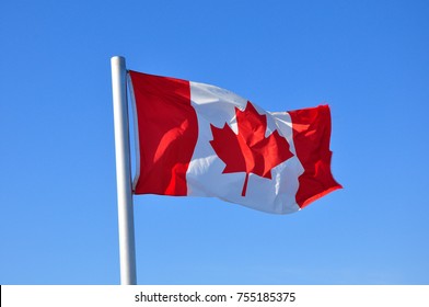 Canada Flag Waving On Blue Sky