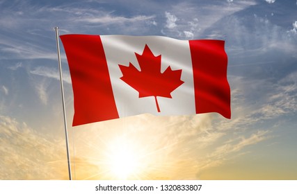 Canada Flag Waving In The Wind Against A Blue Sky And Clouds