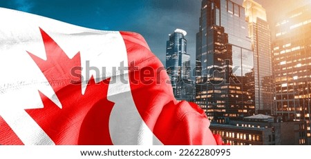 Canada national flag cloth fabric waving on beautiful buildings background.