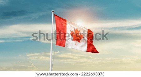 Canada national flag waving in beautiful clouds.