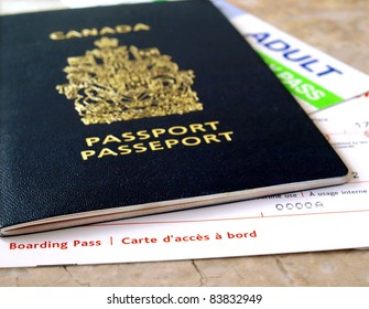 Canada Passport With Boarding Pass On The Table