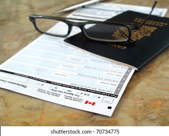 Canada Passport On Declaration Card With Glasses And Pen