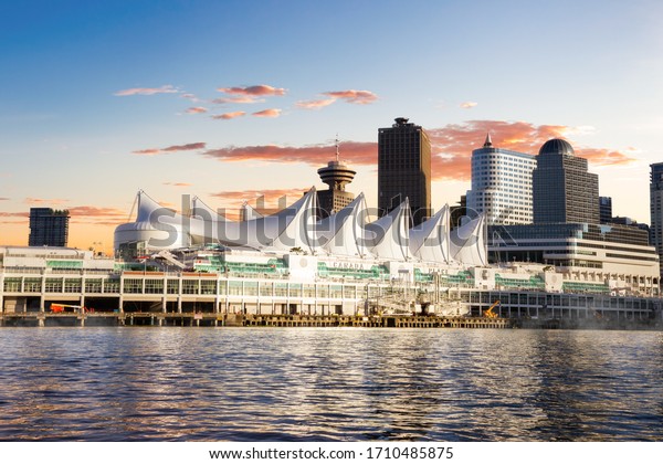 Canada\
Place and commercial buildings in Downtown Vancouver Viewed from\
water during sunset. British Columbia,\
Canada.