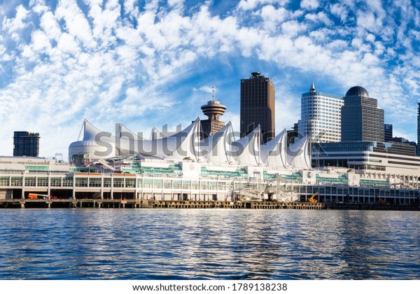 Canada Place and commercial buildings in Downtown\
Vancouver Viewed from water during sunny summer day. British\
Columbia, Canada.