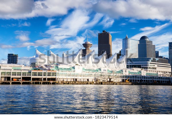 Canada Place and commercial\
buildings in Downtown Vancouver Viewed from water during Blue Sky\
Sunny Day. British Columbia, Canada. Urban Modern City\
Landmark