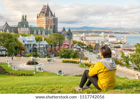 Canada travel Quebec city tourist enjoying view of Chateau Frontenac castle and St. Lawrence river in background. Autumn traveling holiday people lifestyle.