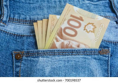 Canadian Banknotes Are In The Back Pocket Of Blue Jeans.