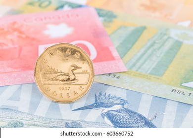 Canadian coin dollar stand on Canada banknote money