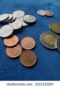 Canadian Coins On A Blue Surface 