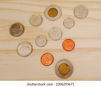 Canadian Coins On A Wooden Background. Canadian Currency