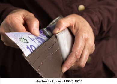 Canadian Currency. Dollars. Money From Canada. Old Retired Person Paying In Cash.