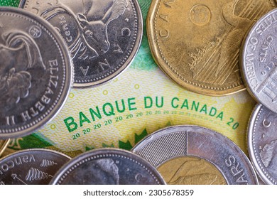 Canadian dollar coins on a Canadian bank note