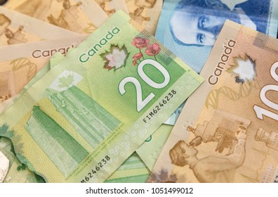 Canadian Dollars, concept of business and finance.Canadian banknotes of different values on a black background