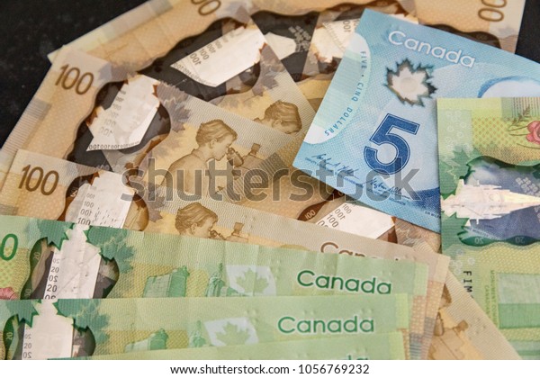 Canadian Dollars,\
concept of business and finance.Canadian banknotes of different\
values on a black\
background