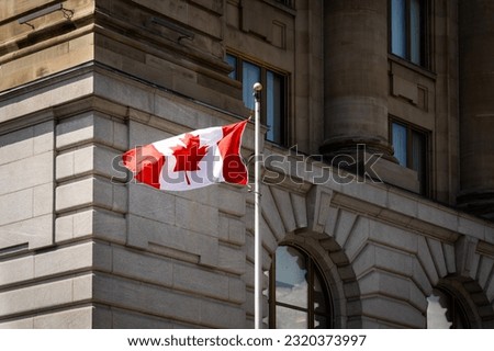 Canadian Flag Flies in front of an heritage Building in Montreal
