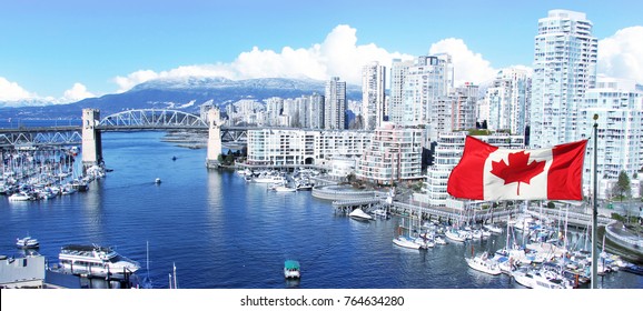 Canadian flag in front of view of False Creek and the Burrard street bridge in Vancouver, Canada. 