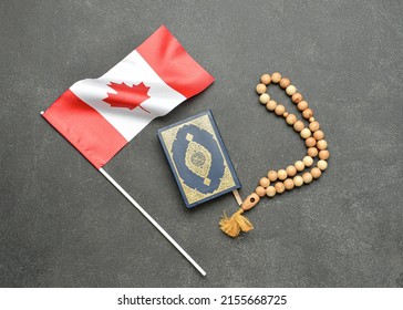 Canadian Flag With Koran And Muslim Prayer Beads On Dark Background