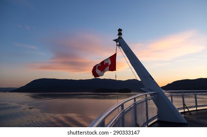 Canadian flag on a ferry at sunset