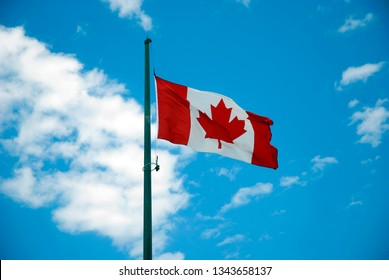 Canadian flag waving on the wind - Shutterstock ID 1343658137