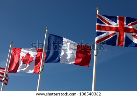 Canadian, french and british flags waving in the wind