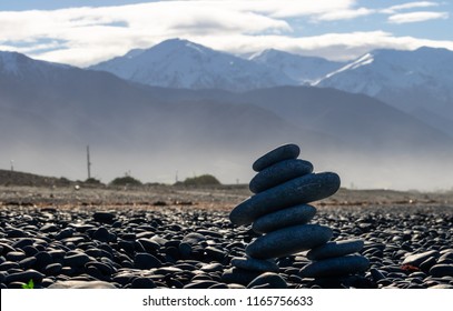 Canadian Inukshuk In Front Of New Zealand Mountains