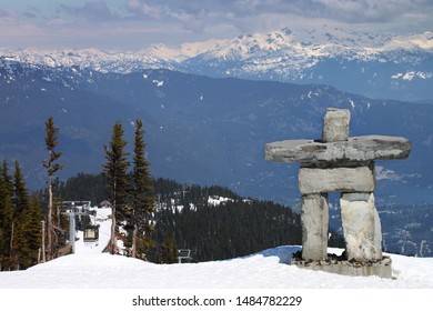 A Canadian Inukshuk Overlooking A Mountain Valley