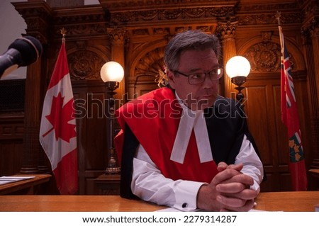 A Canadian judge at his desk in the courtroom listening to the lawyers