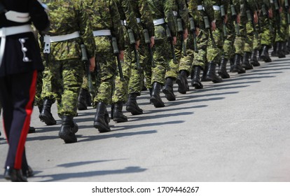 Canadian Military And RCMP In Uniform And Armed Marching In A Line On The Street In York Region
