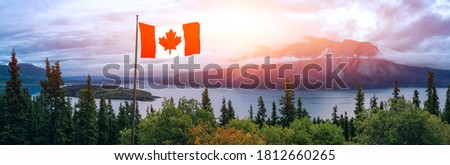 Canadian National Flag composite. Beautiful Panoramic View of Nature Landscape during a colorful cloudy sunrise. Taken in Yukon, Canada.
