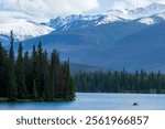 Canadian Rockies summer landscape, snow-capped mountains in the background. Lac Beauvert, or Beauvert Lake in Jasper National Park, Alberta, Canada.