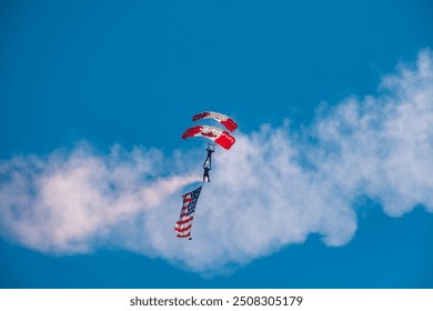 Canadian skydiver with Canadian and American flag. Abbotsford, Canada BC, Abbotsford Airshow 2023. the Canadian International Air Show in North America. Paratrooper Canadian Army forces. - Powered by Shutterstock