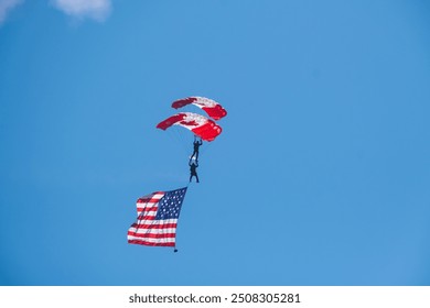 Canadian skydiver with Canadian and American flag. Abbotsford, Canada BC, Abbotsford Airshow 2023. the Canadian International Air Show in North America. Paratrooper Canadian Army forces. - Powered by Shutterstock