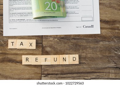 Canadian Tax Refund Spelled With Letter Tiles And Canadian Dollar Notes 