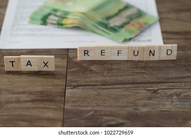 Canadian Tax Refund Spelled With Letter Tiles And Canadian Dollar Notes 