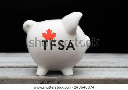 Canadian Tax-Free Savings Account concept with a piggy bank against black background