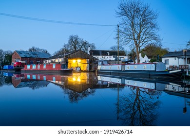 Canal boat dry dock for narrowboat moored repairs at night illuminated and lit up reflecting on long exposure still River Trent water linking to the Grand Union - Powered by Shutterstock