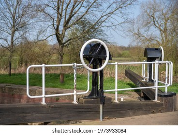 Canal Lock Gate With Paddle Crank Wheel And Metal Railing On Wooden Gate Balance Beam.