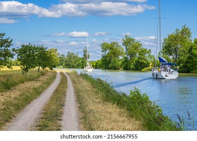 Göta Canal, Sweden, July, 2017, Canal With Sailboats And A Dirt Road