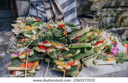 Canang sari. Traditional balinese offerings to gods in Bali with flowers and aromatic sticks. Balinese culture.