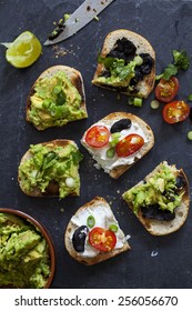 Canapes With Avocado Spread, Goat Cheese And Black Garlic