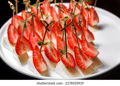 Canapes With Brie Cheese And Ripe Sliced Strawberries. The Concept Of Restaurant Service.