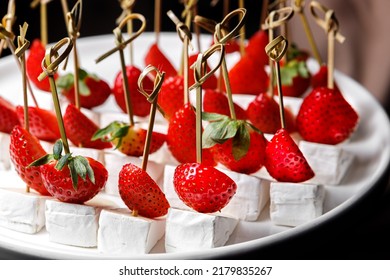 Canapes With Brie Cheese And Ripe Sliced Strawberries. The Concept Of Restaurant Service.