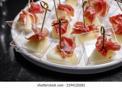 Canapes With Jamon And Juicy Pineapple. The Concept Of Restaurant Service.