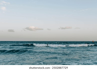 Canary Island, Tenerife-December14,2023.Men and girl professional surfer standing on the sandy beach with his kite and board. Windsurfing, Extreme Sport. High quality photo - Powered by Shutterstock