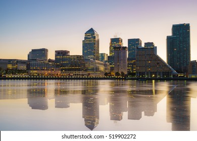 Canary Wharf business district with water reflection at sunset