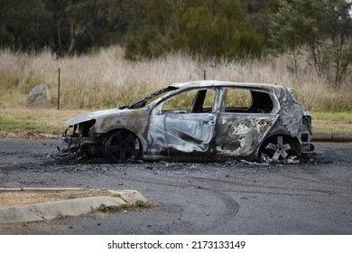 Canberra, Australia - 30 June 2022: A Burnt Out Car Abandoned On A Street (side View).