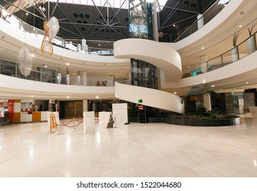 CANBERRA, AUSTRALIA – October 2, 2019: View Of The Spiral Stairway, Glass Elevator And Hanging Pendant Lights In Westfield Belconnen Shopping Centre In Canberra, The Australian Capital Territory